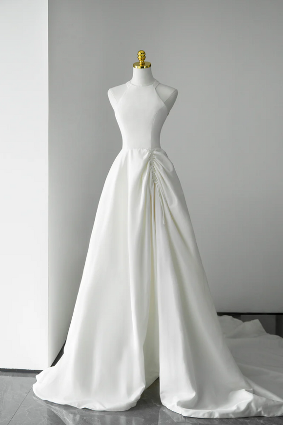 White wedding dress on a mannequin against a gray background