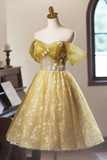 Yellow evening gown with floral details on a mannequin against a neutral background.