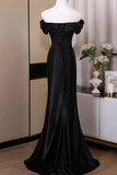 Black evening gown on a mannequin against a neutral background