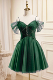 Green dress with sheer sleeves on a mannequin against a decorative wall.