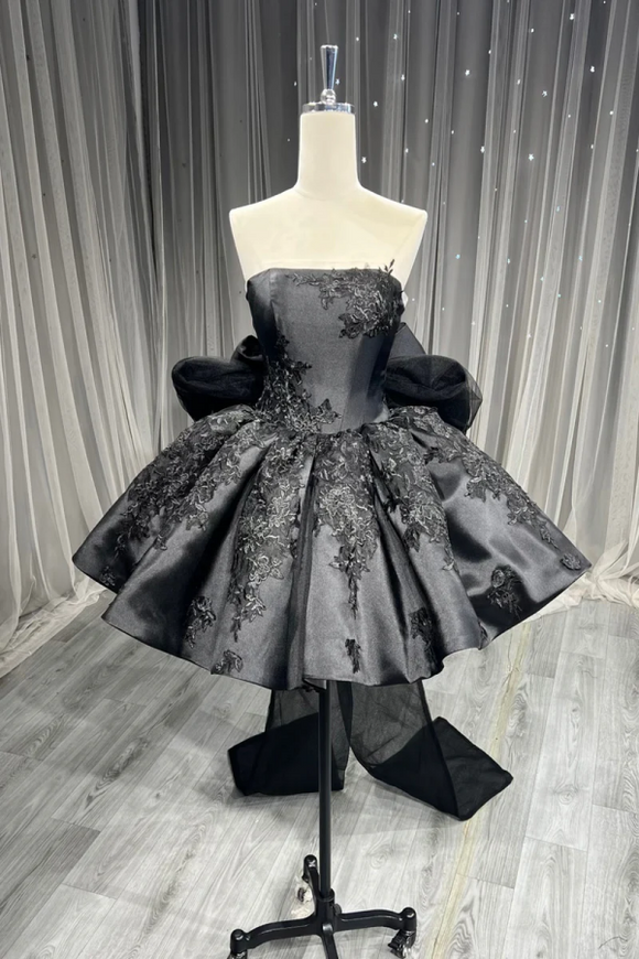 Gray evening gown with floral embroidery on a mannequin against a neutral background