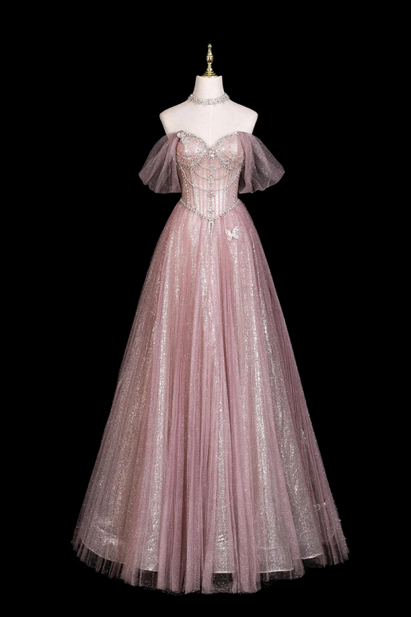 Pink evening gown on a mannequin against a black background