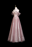 Pink evening gown on a mannequin against a black background
