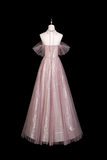 Pink tulle dress on a mannequin against a black background