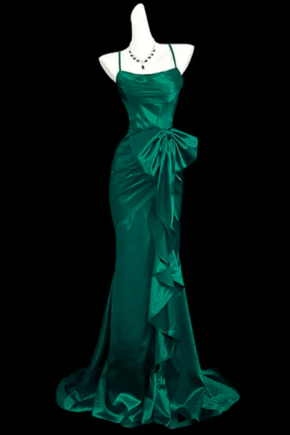 Teal evening gown on a mannequin against a black background