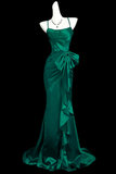Teal evening gown on a mannequin against a black background