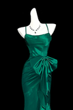Green evening gown on a mannequin with a black background