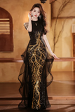Woman wearing a black and gold evening gown in an indoor setting.