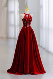 Red evening gown on a mannequin with a blurred white background