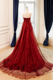 Red evening gown on a mannequin against a window with blue curtains.