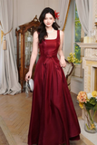 Woman in a red dress standing in an elegant room with decorative elements.