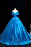 Blue evening gown on a mannequin against a black background