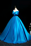 Blue evening gown on a mannequin against a black background