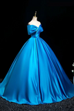 Blue evening gown on a mannequin against a black background