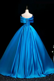 Blue evening gown on a mannequin against a black background