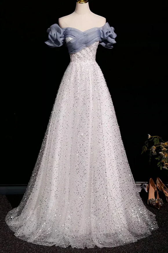 Elegant evening gown with floral details on a mannequin against a black background