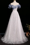 Elegant evening gown with floral details on a mannequin against a black background