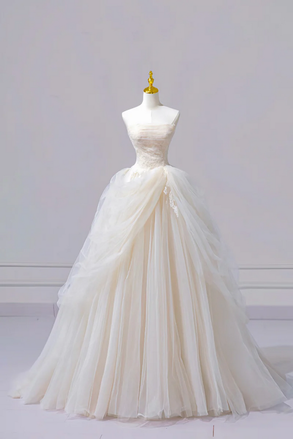 White wedding dress on a mannequin against a plain background