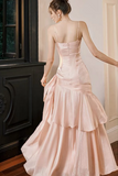 Woman wearing a pink evening gown in an elegant indoor setting