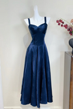 Navy blue evening gown on a mannequin against a white background