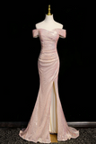 Pink off-shoulder evening gown on a mannequin against a black background