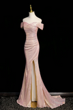 Pink evening gown on a mannequin against a black background