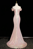 Pink off-shoulder evening gown on a mannequin against a black background