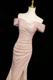 Pink off-shoulder evening gown on a mannequin against a black background