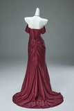 Burgundy evening gown on a mannequin against a gray background