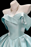 Light blue evening gown on a mannequin with a black background