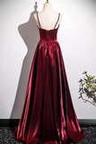 Red satin evening gown on a mannequin against a white background