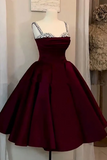 Burgundy dress with white lace top on a mannequin against a neutral background