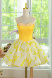 Yellow dress with floral pattern on a mannequin in front of a window