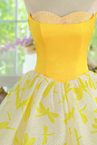 Yellow strapless top with a white skirt featuring yellow floral patterns on a mannequin.