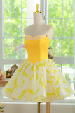 Yellow and white dress on a mannequin in front of a window with greenery.