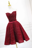 Red sparkly dress on a mannequin against a white background
