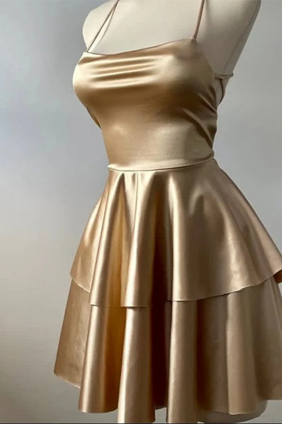 Gold dress on a mannequin against a neutral background