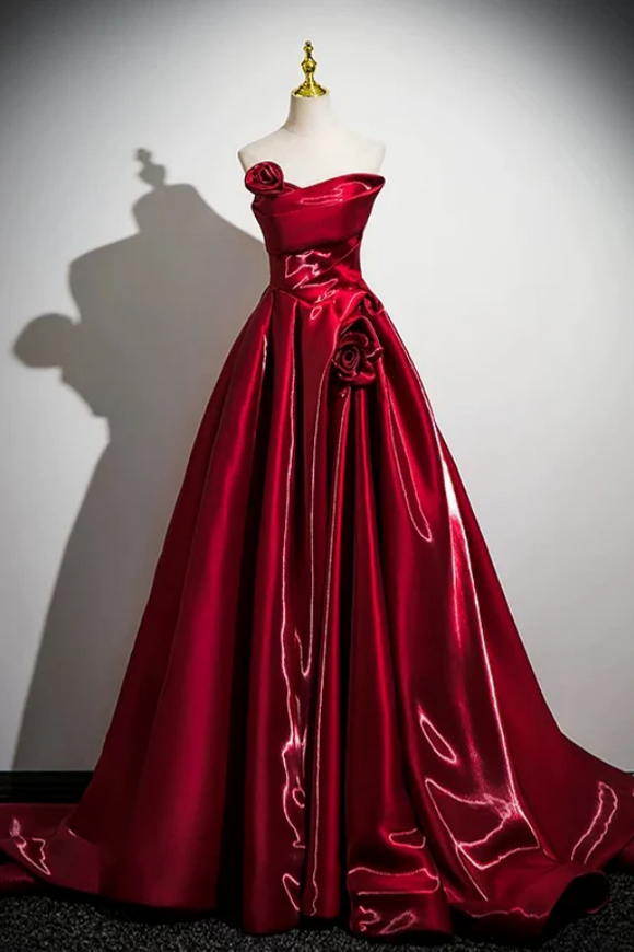 Red evening gown on a mannequin against a white background