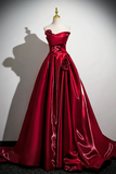 Red evening gown on a mannequin against a white background