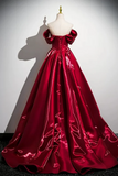 Red evening gown on a mannequin against a white background