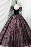Gothic-style dress with floral pattern on a mannequin against a white curtain background