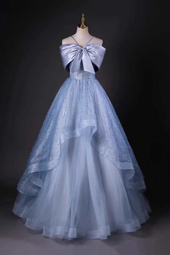 Light blue evening gown with a large bow on a mannequin against a dark background