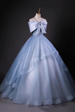 Light blue ball gown with a large bow on a dark background