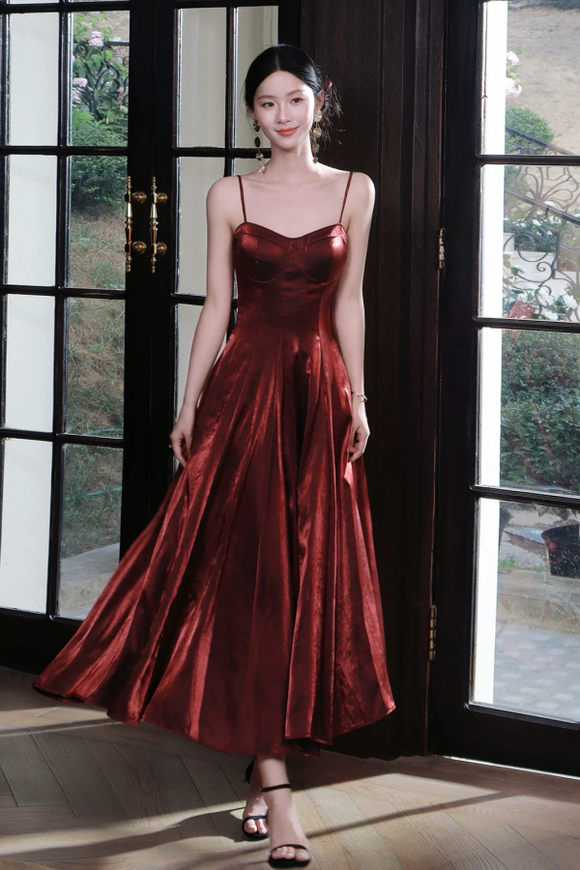 Woman in a red dress standing in front of a large window