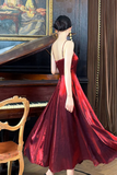 Woman in a red dress standing in front of a piano in an elegant room.