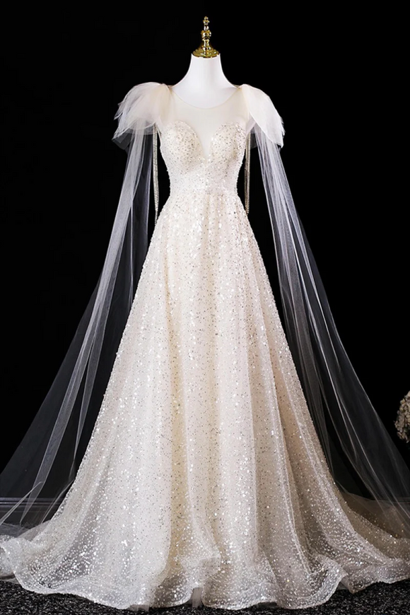 Elegant white wedding dress with a long train on a mannequin against a black background