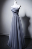 Gray strapless evening gown on a mannequin against a plain background