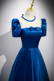Blue dress on a mannequin against a gray background