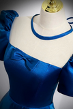 Blue dress on a mannequin with a plain background