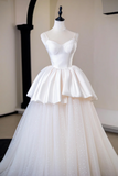 White wedding dress on a mannequin against a plain background